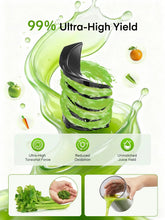 Black cold press juicer with green juice stream and leafy greens being processed.