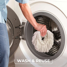Hand rinsing a white microfiber spin mop pad inside gray bucket