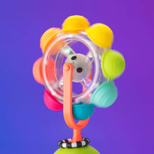 Light-up spinning rainbow reel toy on orange stand with colorful ear-like knobs