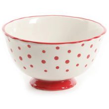 Polka-dot ceramic dinner bowl with red rim and pedestal base, white interior