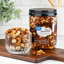 Jar of Great Value Deluxe mixed nuts beside bowl of assorted nuts on wooden tray