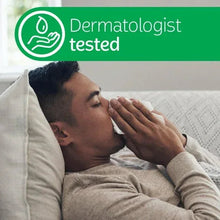 Dermatologist-tested lotion tissue use, man dabbing his face with a tissue