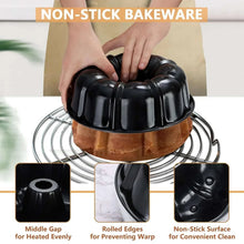 Black bundt cake pan with fluted sides and center tube on cooling rack.