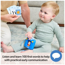 Talking flash card reader toy and word cards held while a toddler looks on