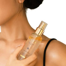 d'Alba First Spray Serum bottle close-up on hand and neckline