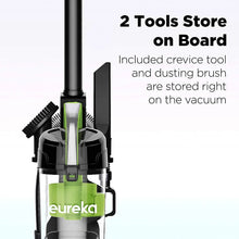 Upright vacuum showing on-board tool storage, crevice tool and dusting brush
