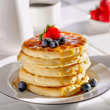 Mini waffle maker serving stack of waffles with strawberries and blueberries