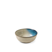 Reactive ceramic soup bowl with beige glaze and blue rim