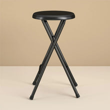 Black folding stool with round padded top and crossed metal legs