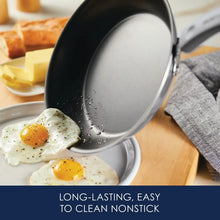 Gray nonstick frying pan with lid flipped up, showing eggs in skillet