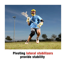 Black hinged knee brace worn on bent knee during outdoor activity
