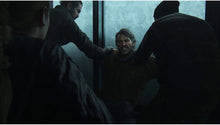 PlayStation 5 game screenshot: people helping an injured man at a doorway