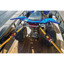 Ratchet tie-down straps securing equipment on a truck bed
