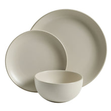 Stacked cream matte dinnerware bowls and cups