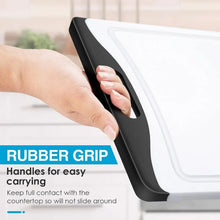 White plastic cutting board with black grip handle and recessed juice groove channel
