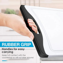 Plastic cutting board with dark rubber grip handle, white surface with recessed border