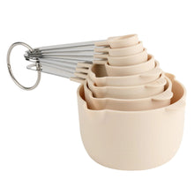 Light gray measuring cups and spoons set with ring-shaped metal handle
