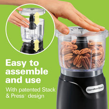 Hamilton Beach electric food chopper with clear bowl, black base, and hands