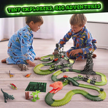 Dinosaur track STEM set on the floor with dinosaur figures and toy vehicles