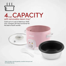 Pink rice cooker with removable steam tray and inner pot, shown with lid and base