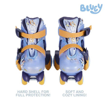 Pair of kids roller skates, light blue boots with navy accents and orange straps