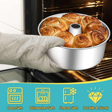 Stainless steel tube cake pan with baked cake inside, pan on oven rack