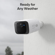 eufy SoloCam C210 wireless outdoor camera mounted on a wall, raindrop speckled