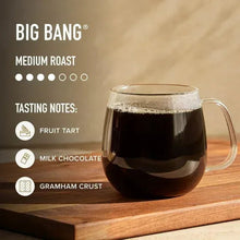 Glass mug filled with dark brewed coffee next to Big Bang medium roast tasting notes