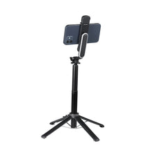 Black selfie stick tripod with phone clamp and built-in LED light panel on stand