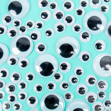 Close-up of black plastic wiggle eyes with white rings and clear domes