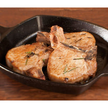 Square cast iron skillet with short handle, roasted food with herbs in dark cooking surface.
