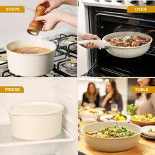 Cream white cookware set with saucepans on stovetop and sauté pan in oven