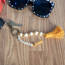 Keychain bracelet with silver-tone beads and gold spacer beads, tassel accents