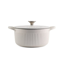 White enameled cast iron dutch oven with lid, knob, ribbed sides, loop handles.