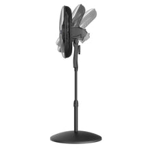 Black pedestal fan standing on round base with adjustable height pole