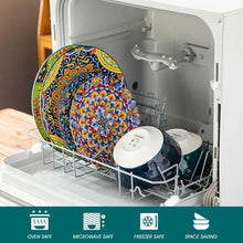Colorful ceramic plates and bowls in an open dishwasher, boho mandala pattern
