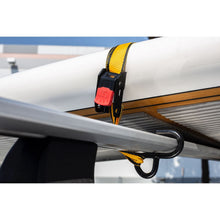 Tie-down cam buckle with yellow webbing attached to a rail