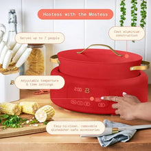Tomato red multi-cooker on a countertop with lid and control panel