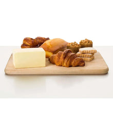 Salted sweet cream butter block on wooden cutting board, beside butter portions