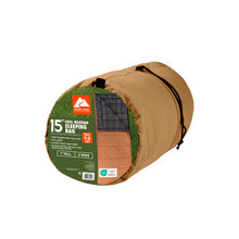 Tan rectangle sleeping bag in rolled storage bundle with black trim and strap