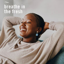 Febreze PLUG air freshener product campaign with a woman relaxing; no product visible