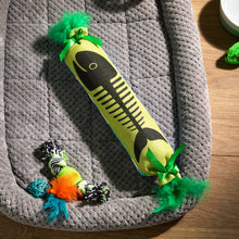 Fish bone cat kicker toy with green pom pom ends and black-and-lime fish-bone design