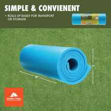 Rolled blue closed-cell foam camping sleeping pad on grass surface
