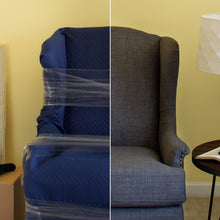 Clear plastic stretch wrap securing a blue upholstered sofa section