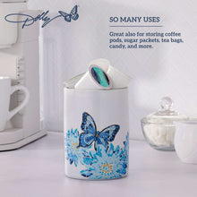 White cylindrical stoneware crock with blue butterfly and flower design, for kitchen storage