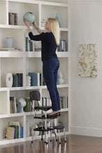 Black retro step stool with padded seat and back, chrome frame, and three steps