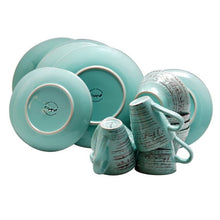 Turquoise wave-pattern dinnerware set with plates, cups, and stacked bowls