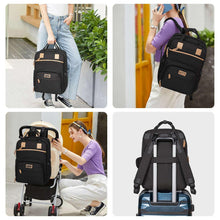 Large baby diaper backpack in black with tan trim, front zip pocket and side compartments