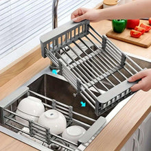 Over-sink dish drying rack with raised supports holding plates and cups