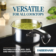 Stainless steel saucepan with black handle and pour spout, filled with green sauce